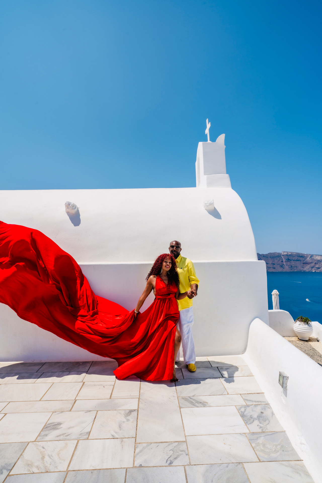 Demishia and her husband in Santorini, Greece, overlooking the Aegean Sea